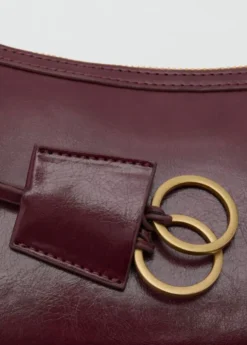 Crossbody bag with charms and rings